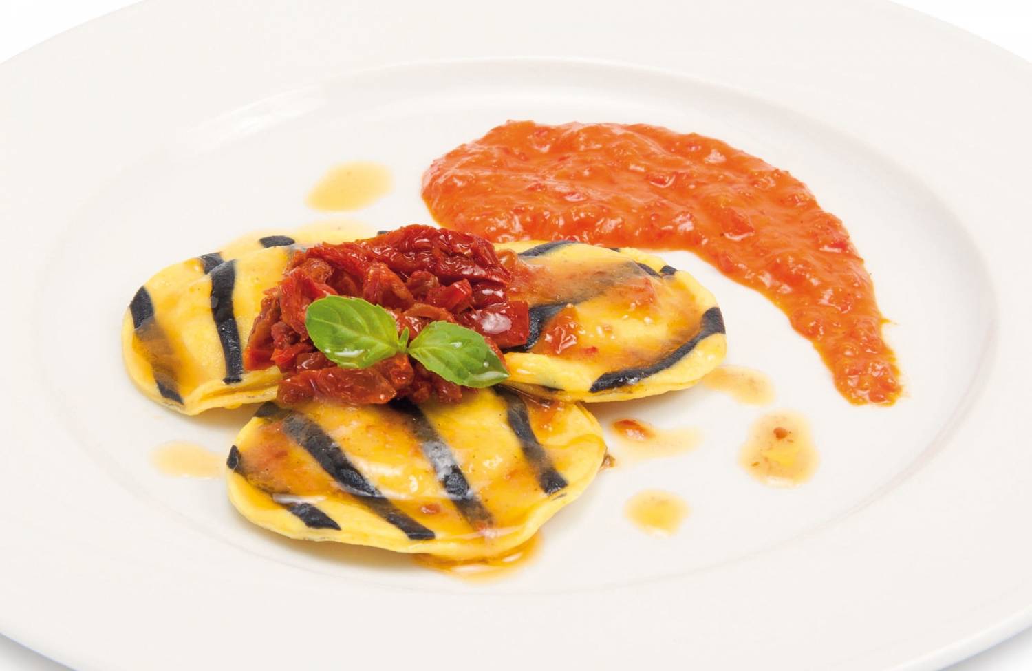 Codfish ravioli with peppers cream and dried tomato fillets