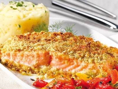 Pistachio salmon steak with roasted potatoes and peppers
